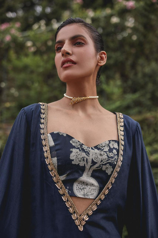 Close-up of antique-gold floral embroidery on the bell-sleeve cuff of the Shajar cotton modal kurta in navy