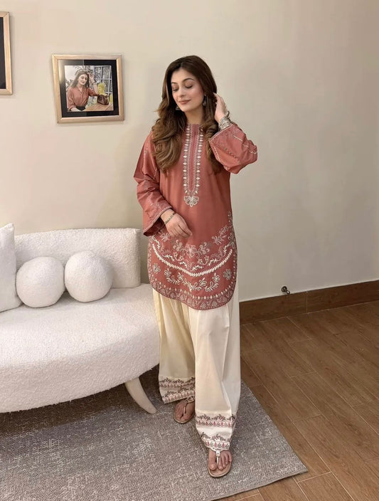 Gulrang rose cotton modal kurta styled at home with cream wide-leg pants and matching embroidered hem